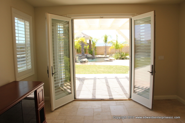 French doors opened to reveal bright, sunny patio